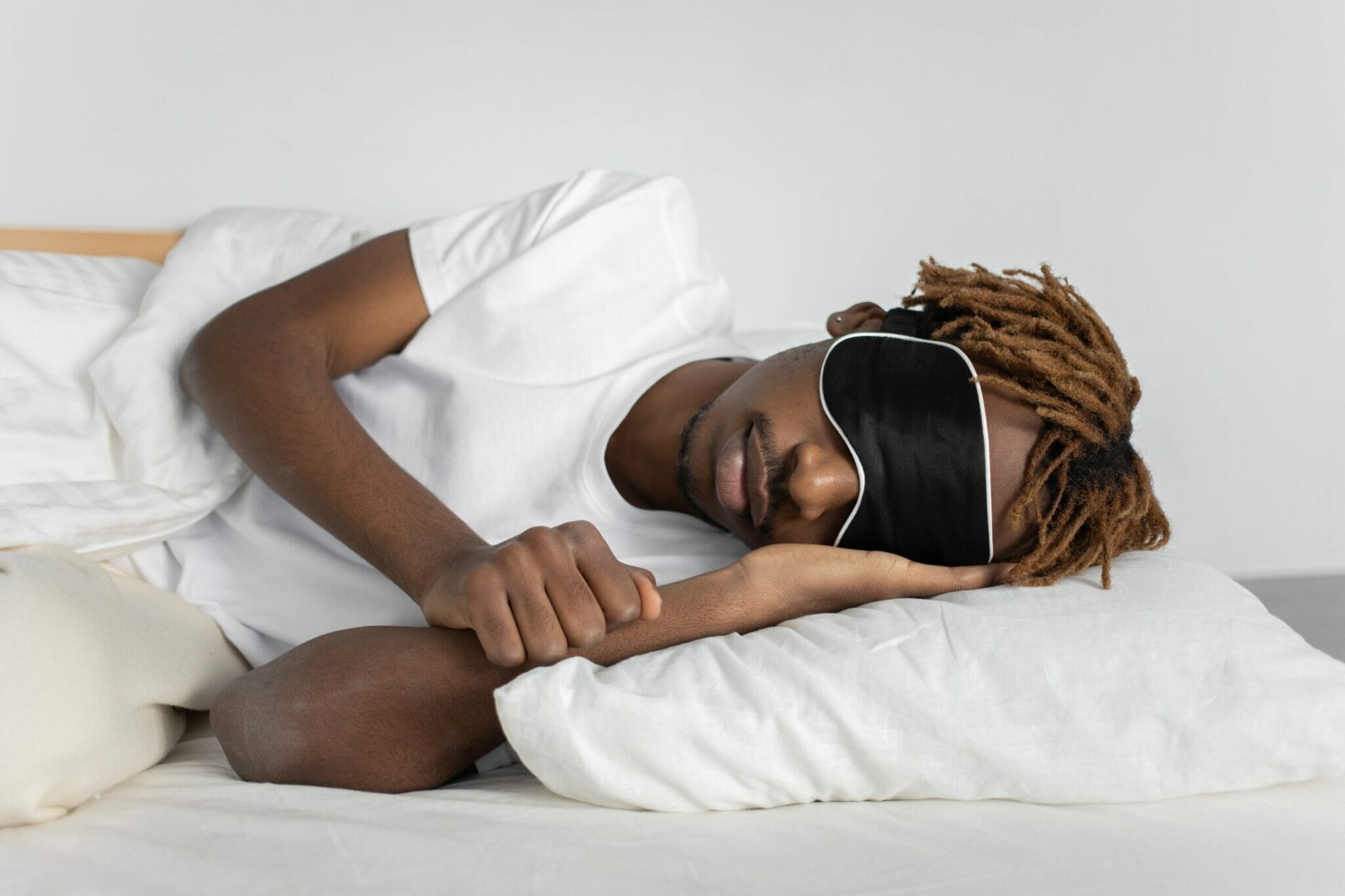 man sleeping with a sleeping mask