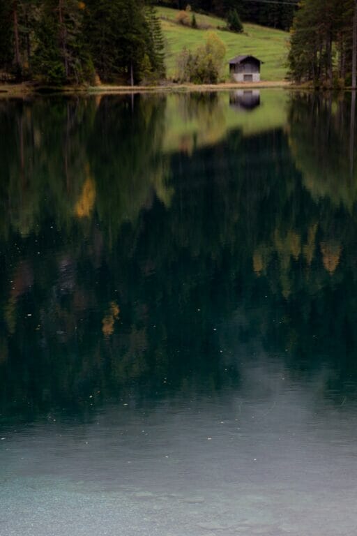 photograph of a reflective calm lake